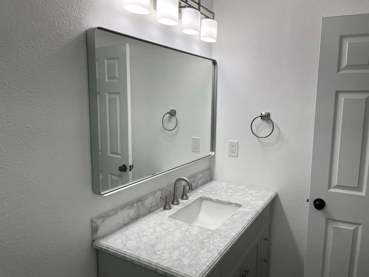 Painted gray bathroom walls above a marble vanity