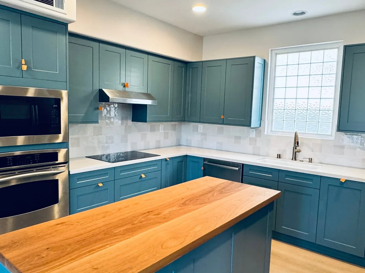 Blue cabinets painted around a stainless wall oven