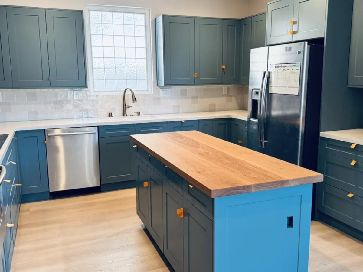 Blue painted kitchen cabinets with butcher block island