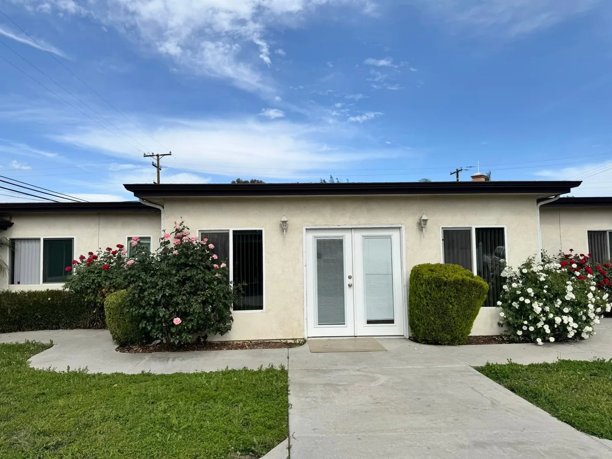 Cream stucco exterior with white painted french doors