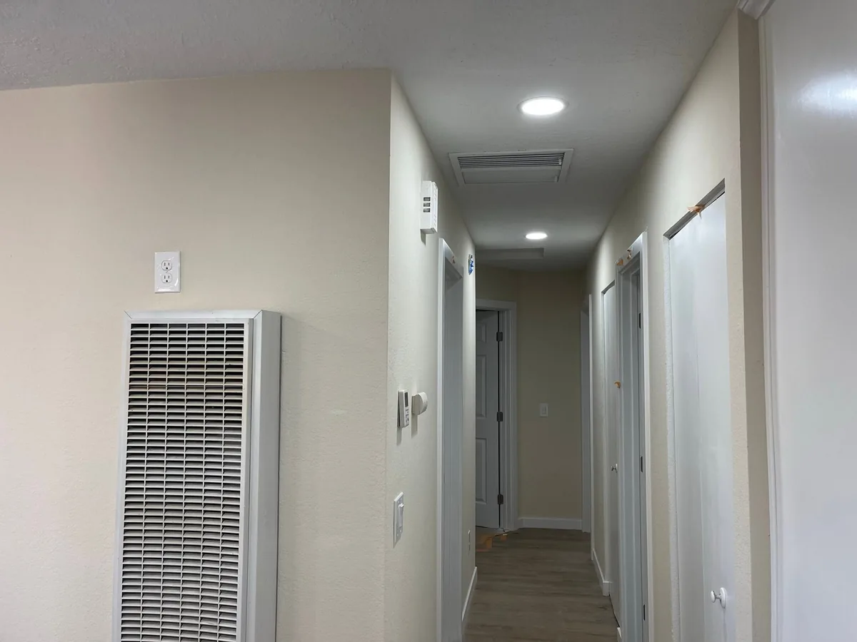 Freshly painted white hallway walls and door frames