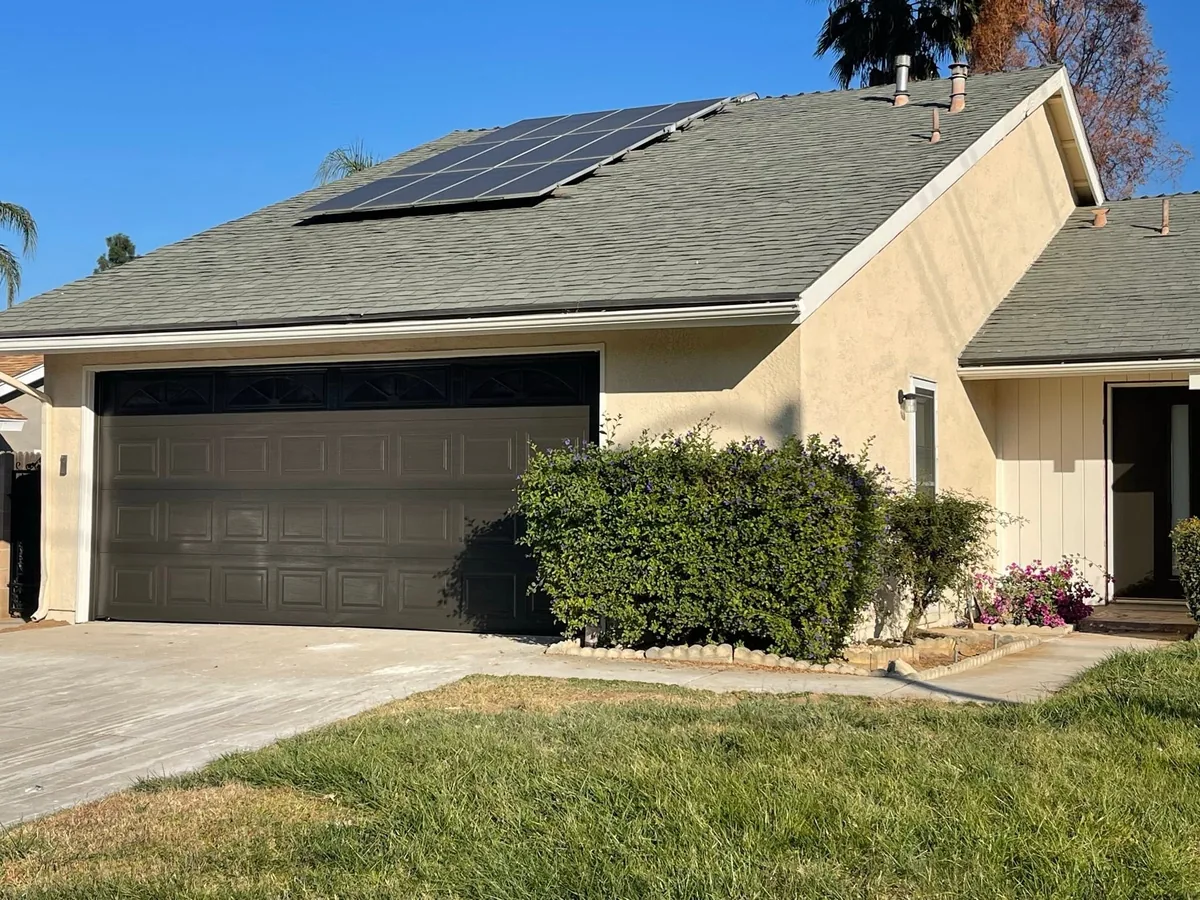 Tan stucco exterior painted with a matching garage door