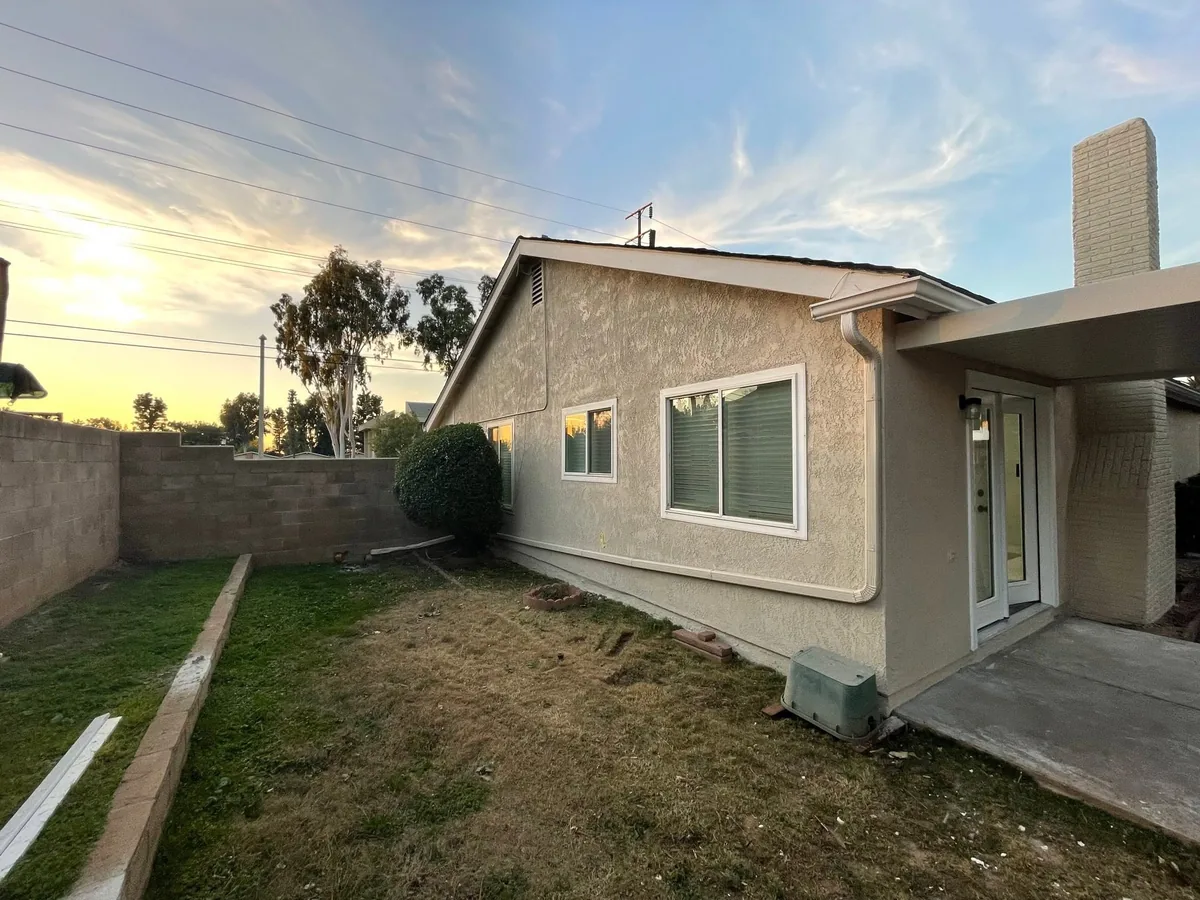 Repainted tan stucco exterior on a single story home